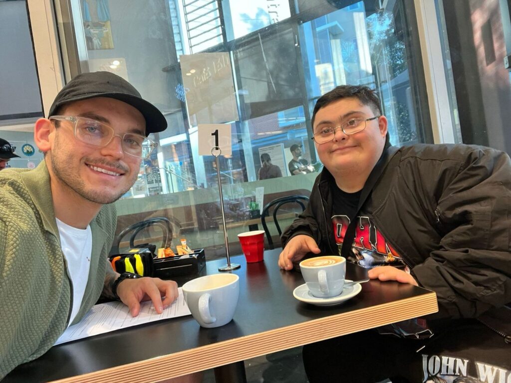 A Morhaven support worker and a member over coffee at a cafe.